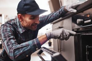 Repairman fixing an oven